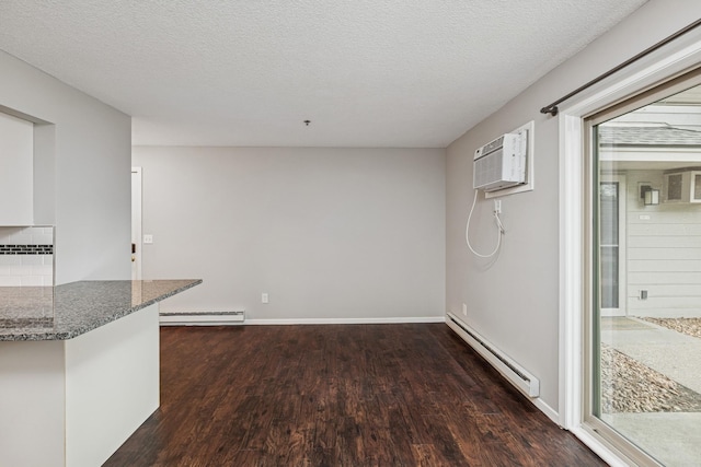 2110 Ridge Dr Unit 11, Saint Louis Park, MN 55416 - unfurnished dining area featuring a baseboard heating unit, a wall mounted AC, a baseboard radiator, wood finished floors, and a textured ceiling