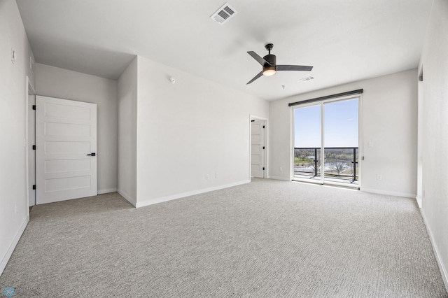 unfurnished room with baseboards, carpet, a ceiling fan, and visible vents