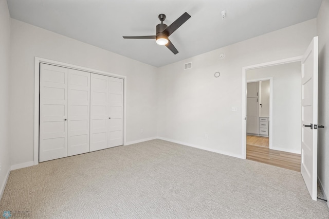 unfurnished bedroom featuring visible vents, a closet, baseboards, ceiling fan, and carpet flooring