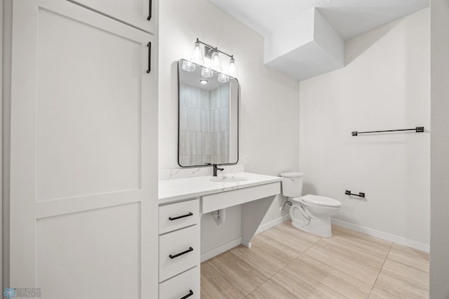full bathroom with toilet, baseboards, and vanity