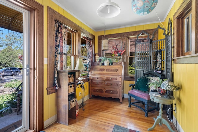 sitting room featuring light wood finished floors and crown molding