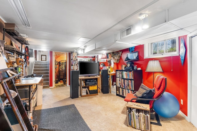finished basement with carpet, visible vents, and stairs
