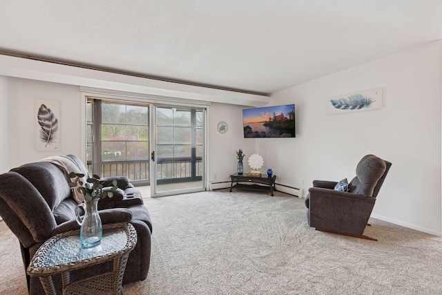 living area with baseboards and carpet