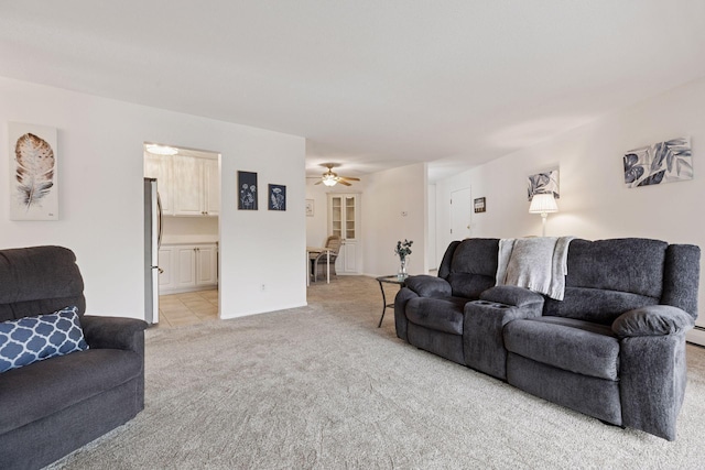 living room with baseboards, ceiling fan, and light carpet