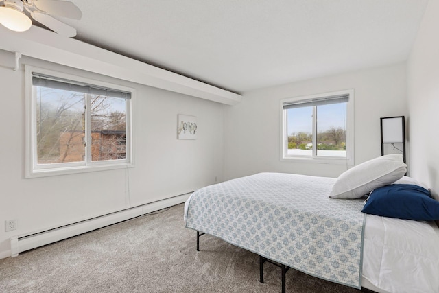 carpeted bedroom featuring baseboard heating