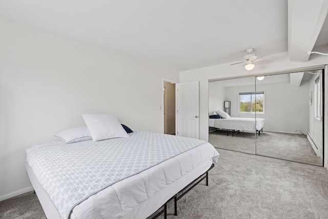 bedroom featuring a closet, baseboards, ceiling fan, a baseboard heating unit, and carpet flooring