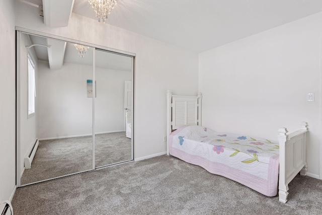 carpeted bedroom with baseboards, a baseboard radiator, a closet, and a chandelier