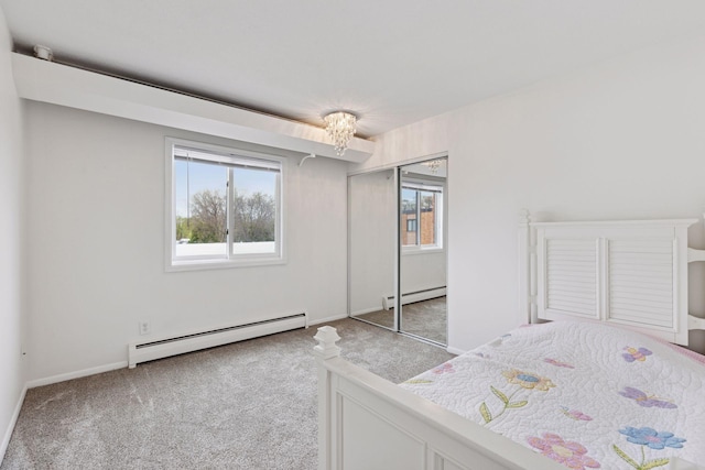bedroom featuring carpet flooring, a notable chandelier, a baseboard heating unit, and baseboards