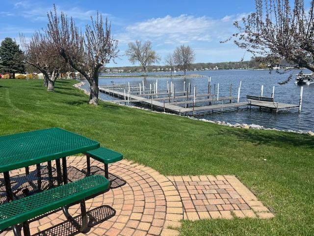 dock area featuring a lawn and a water view