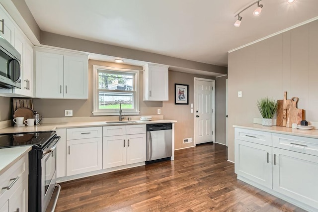 kitchen featuring stainless steel appliances, a sink, white cabinetry, and light countertops