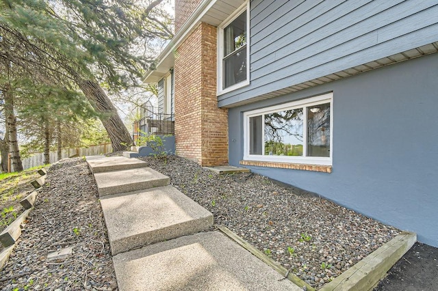 view of side of home featuring fence