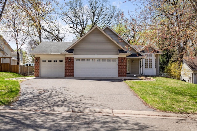 single story home with brick siding, fence, driveway, and a garage