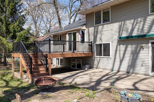 back of property featuring a patio, an outdoor fire pit, a wooden deck, and stairway