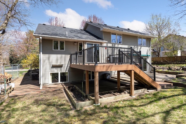 back of house with a yard, a deck, fence, and stairs