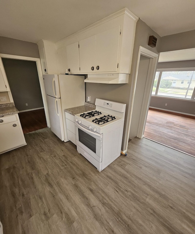 kitchen featuring white appliances, white cabinetry, under cabinet range hood, and wood finished floors