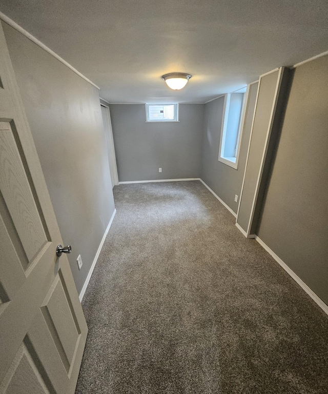 below grade area with baseboards and carpet