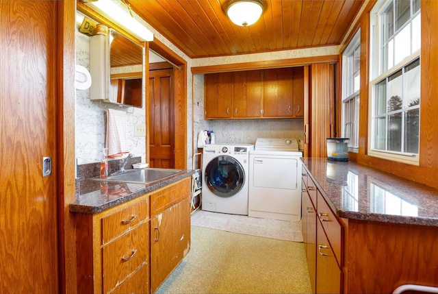 laundry area with a sink, cabinet space, independent washer and dryer, and wood ceiling
