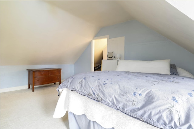 bedroom with carpet flooring and lofted ceiling