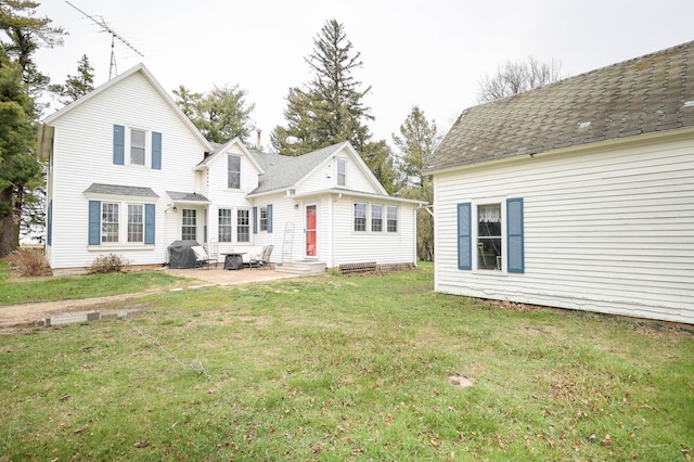 rear view of house with a lawn, a patio area, and entry steps