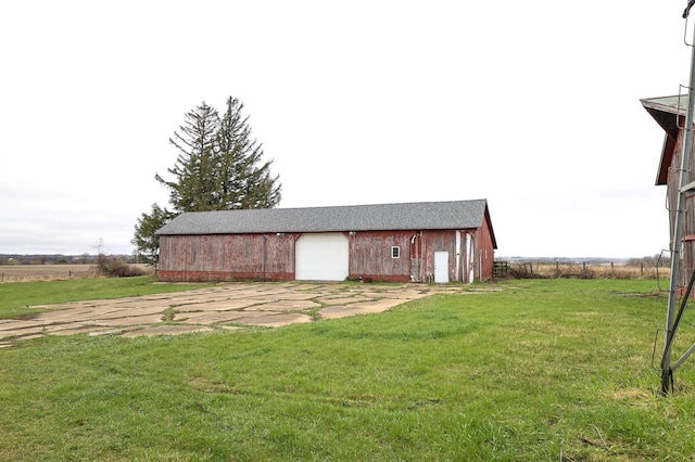 view of outdoor structure featuring an outbuilding and concrete driveway