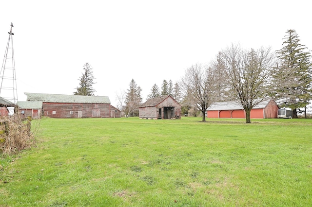 view of yard with a barn and an outbuilding