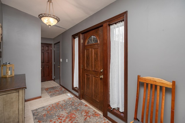 entrance foyer with light tile patterned flooring and baseboards