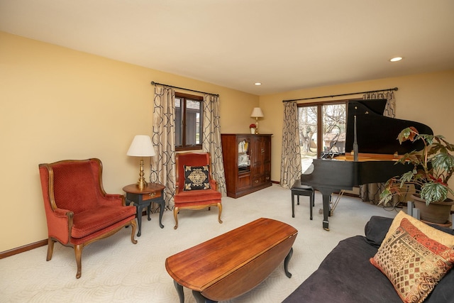 living area featuring recessed lighting, carpet, and baseboards