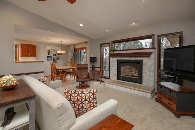 living area featuring light colored carpet, a brick fireplace, recessed lighting, a ceiling fan, and vaulted ceiling
