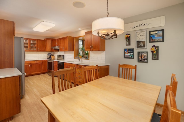 dining area featuring recessed lighting, light wood finished floors, and a chandelier