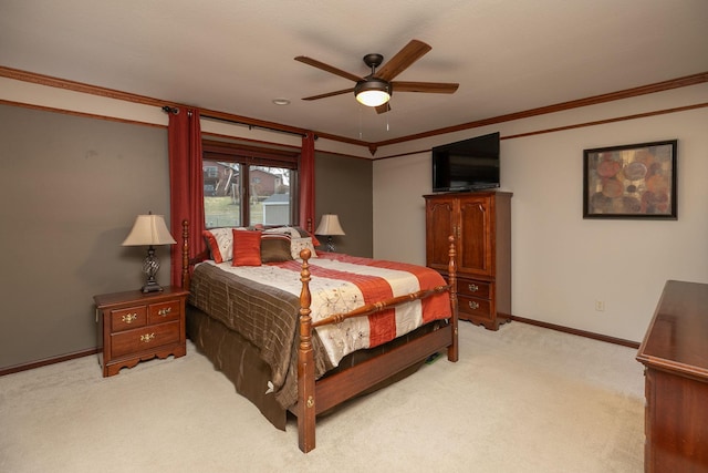 bedroom featuring light colored carpet, ornamental molding, baseboards, and a ceiling fan