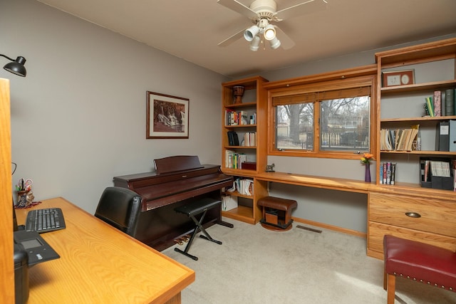 office space featuring carpet floors, a ceiling fan, baseboards, and visible vents