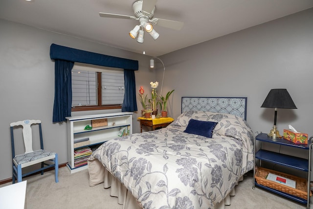 carpeted bedroom with a ceiling fan and baseboards