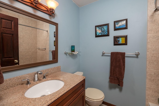 bathroom with toilet, walk in shower, and vanity