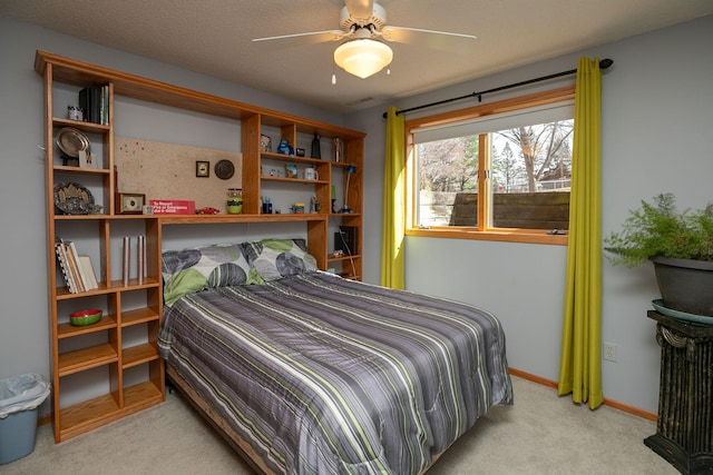 carpeted bedroom with a ceiling fan and baseboards