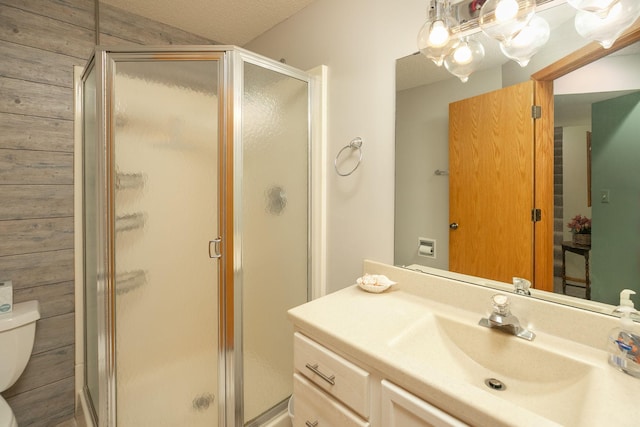 full bath with vanity, a stall shower, and toilet