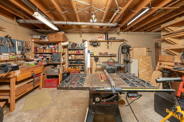 unfinished basement featuring a workshop area