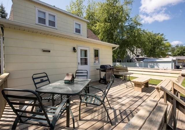 106 4th St, Cyrus, MN 56323 - wooden terrace with outdoor dining area and a grill