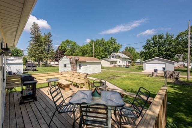 106 4th St, Cyrus, MN 56323 - wooden terrace with a lawn, an outbuilding, outdoor dining area, and a grill