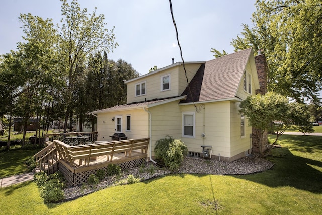 106 4th St, Cyrus, MN 56323 - back of property with a yard, a chimney, a wooden deck, and a shingled roof