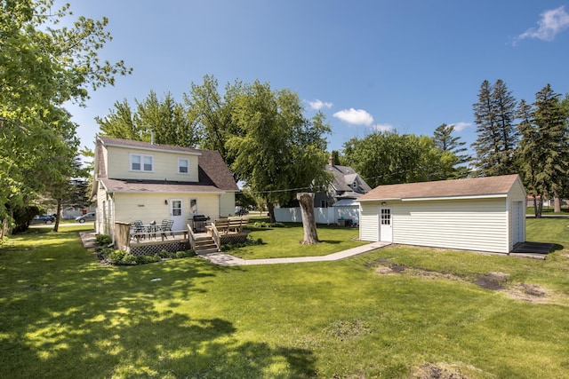106 4th St, Cyrus, MN 56323 - rear view of house with a lawn, an outbuilding, and a wooden deck