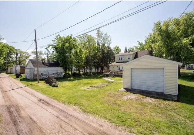 106 4th St, Cyrus, MN 56323 - view of yard with an outdoor structure and a garage