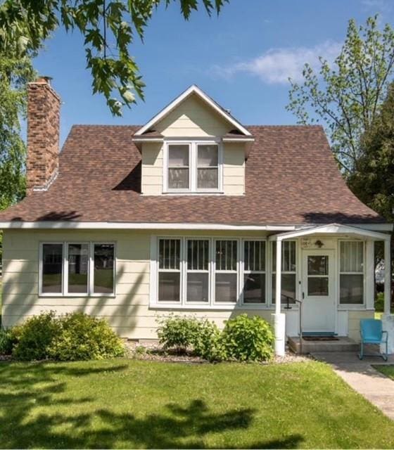 106 4th St, Cyrus, MN 56323 - bungalow-style home featuring a chimney, a shingled roof, and a front lawn