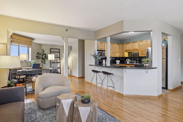 living room with light wood-type flooring and baseboards