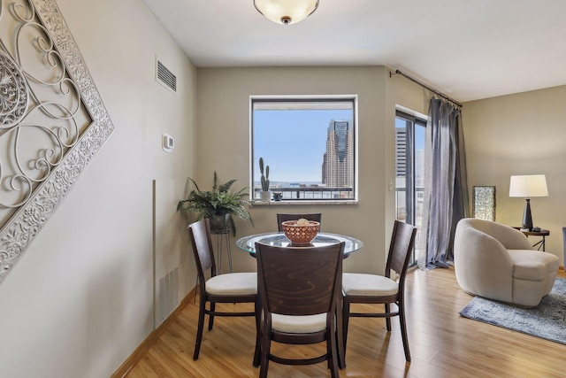 dining space featuring wood finished floors and visible vents