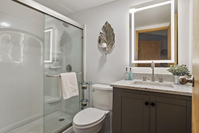 full bathroom featuring toilet, a shower stall, and vanity