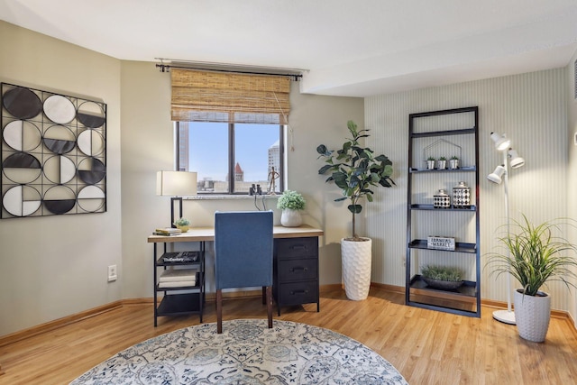 home office featuring baseboards and wood finished floors