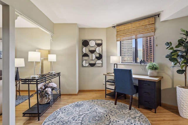 office area with baseboards and wood finished floors