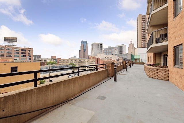 view of patio / terrace featuring a view of city and a balcony