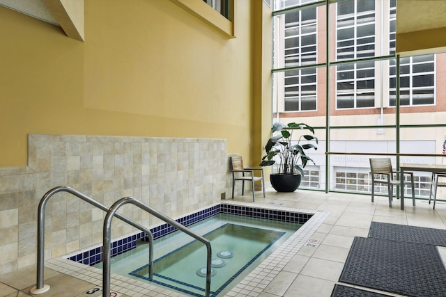 view of swimming pool featuring an indoor hot tub