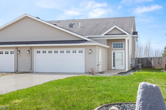 view of front of home with fence, a front yard, central AC unit, concrete driveway, and an attached garage